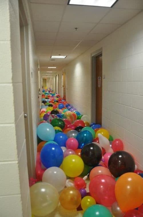 Hundreds of balloons in the office hallway